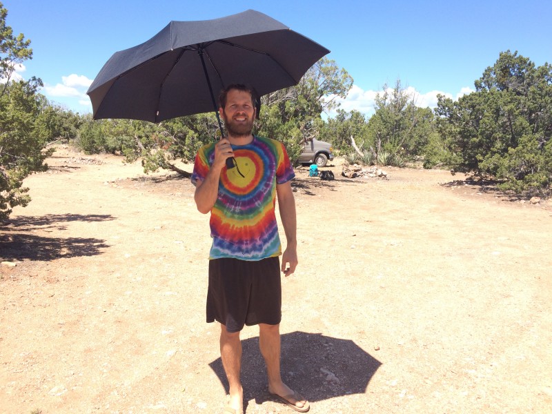 John continuing to use an umbrella to shield his sunburnt shoulders