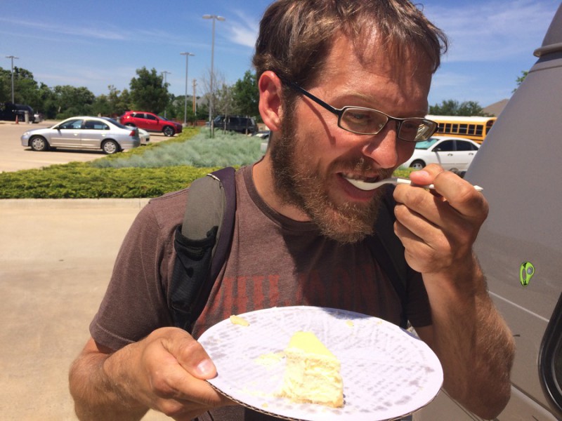John enjoying cheesecake in the library parking lot