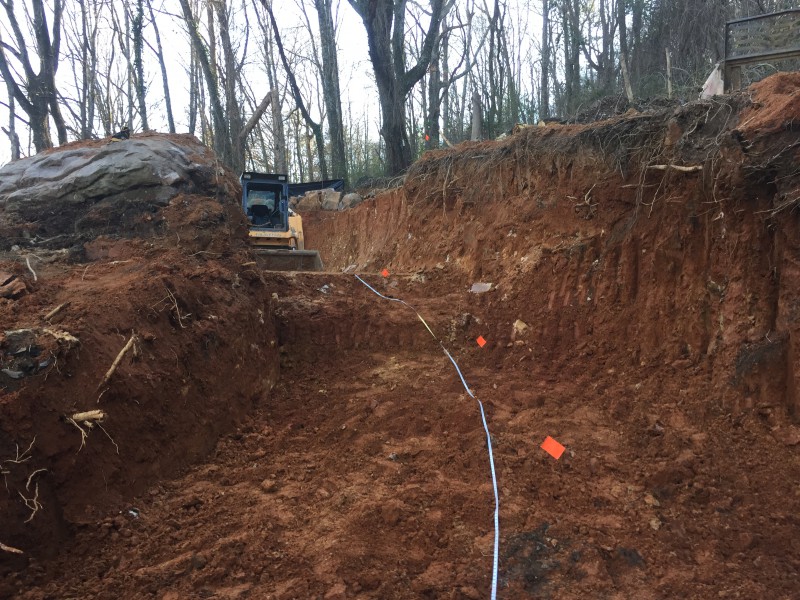 Early stages of the driveway excavation. It gives an idea of just how much we had to dig down in order to achieve a grade of <15%.