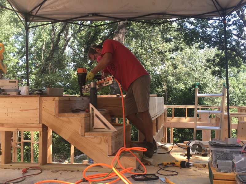 John building one of the small sets of stairs that lead from the half floor to the second floor