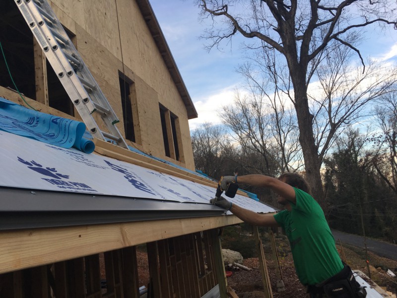 Installing the eave trim that each panel hooks into
