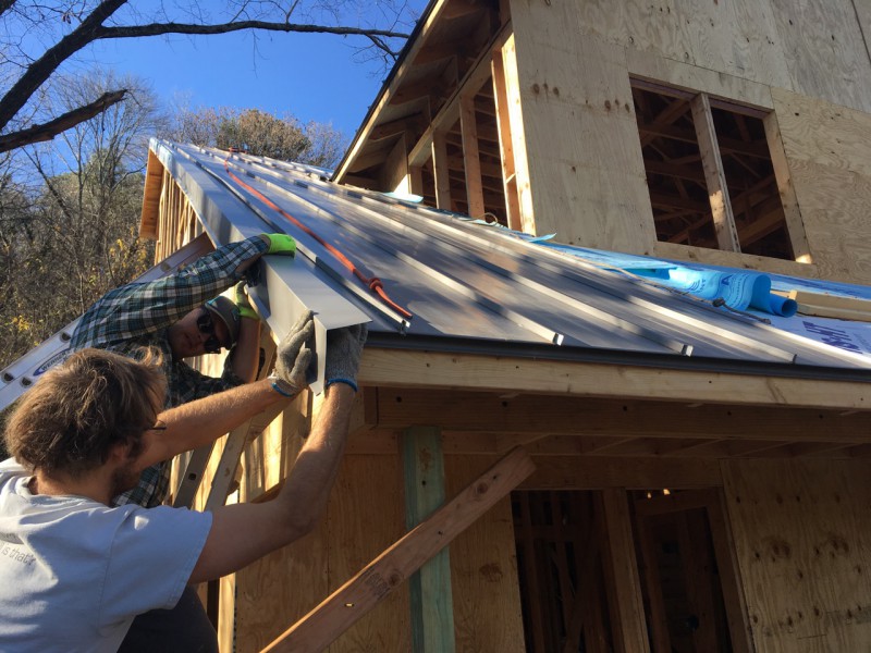 Installing the dreaded rake edge. It got harder when we were attaching pieces that were too far off the ground to reach from a ladder.