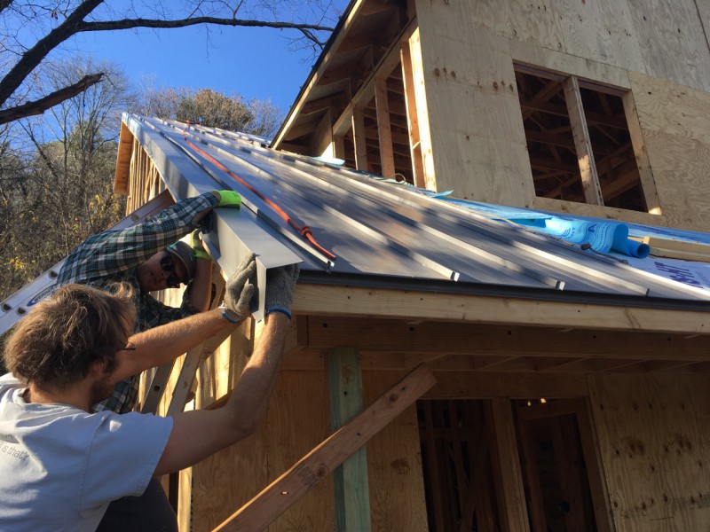 Installing the dreaded rake edge. It got harder when we were attaching pieces that were too far off the ground to reach from a ladder.