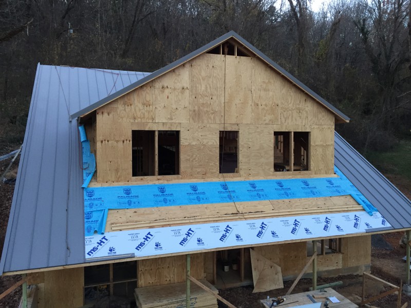 The front view of the house. We chose not to roof the front porch until we finish sheathing the dormer, since it's difficult to access that part of the house from the ground.