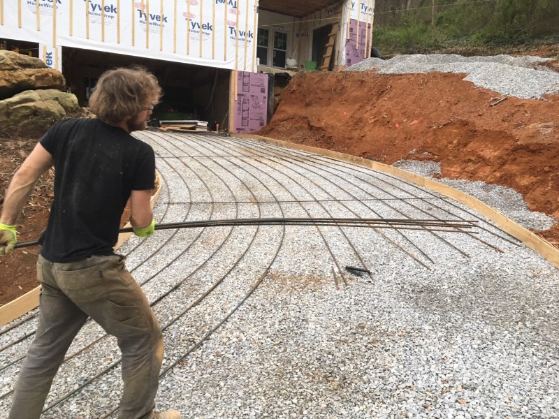 John laying rebar and working to get it to curve with the driveway