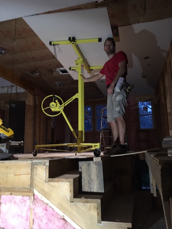 We created some creative - and moderately unstable - supports to use the drywall lift above staircases.