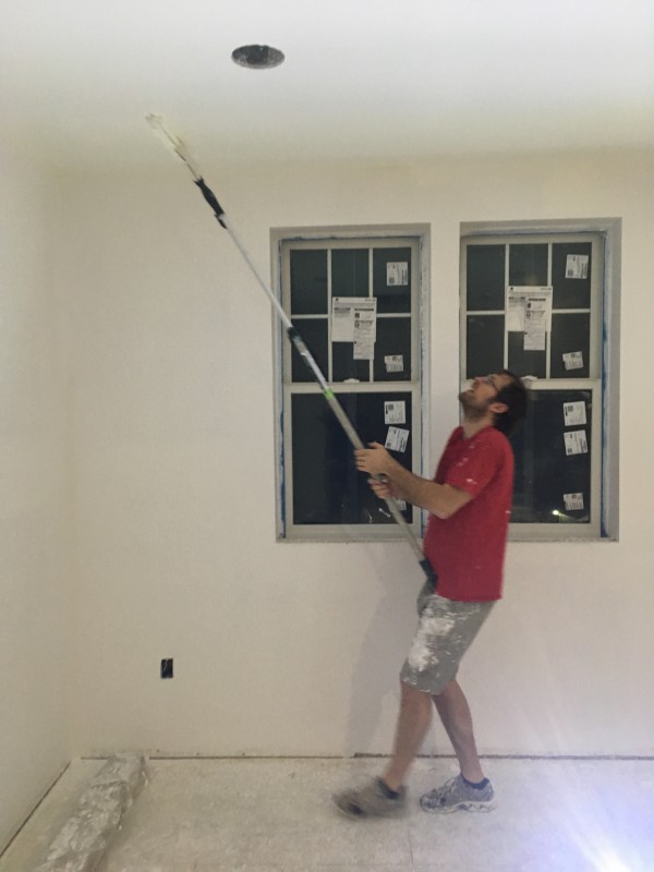 John using his hip to reduce shoulder stress while painting ceilings